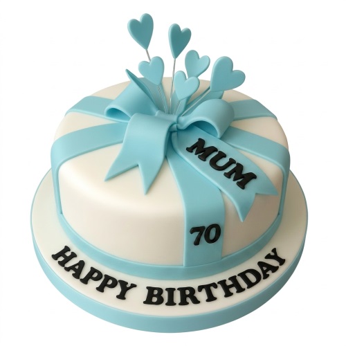 White and light blue gift box style birthday cake with a large bow and heart toppers.
