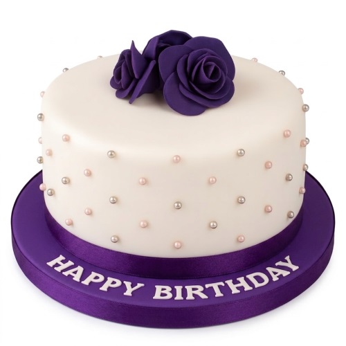 White round birthday cake with purple fondant roses, pink and silver pearls, and a 'Happy Birthday' message.