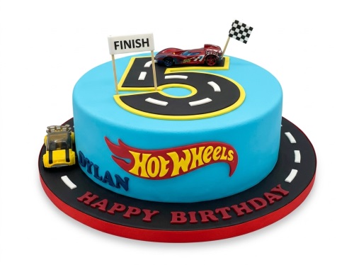 Blue Hot Wheels themed birthday cake with a custom age '5' road, toy racing car, finish line, and personalised name.