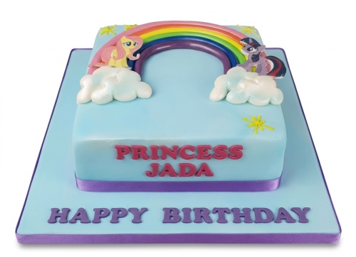 Light blue My Little Pony birthday cake with rainbow, clouds, and two pony characters.