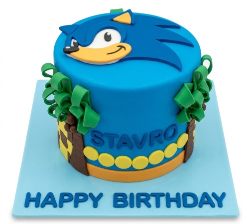 Round blue Sonic The Hedgehog birthday cake with 3D Sonic topper, green curly decorations, and game-themed details.