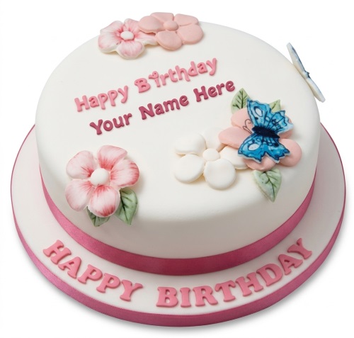 Round white birthday cake with pink and white flowers, a blue butterfly, and a pink ribbon.