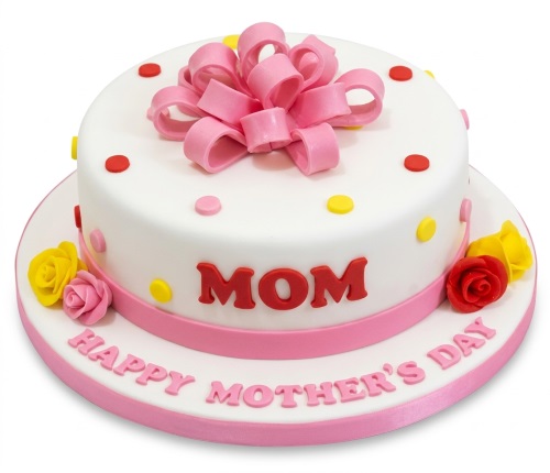 White Mother's Day cake with pink bow, red and yellow polka dots, and pink, red, yellow roses.