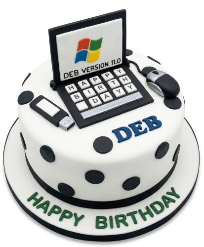 White round birthday cake with black polka dots, topped with a 3D laptop, mouse, and USB drive.
