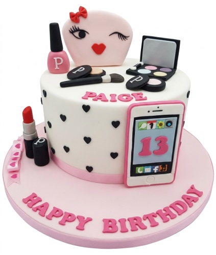 Two-tier white and pink cake with makeup decorations, mobile phone with custom age, and personalised name.