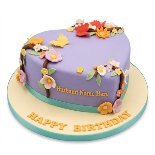 Heart-shaped lavender birthday cake with colourful edible flowers, butterflies, and custom name.