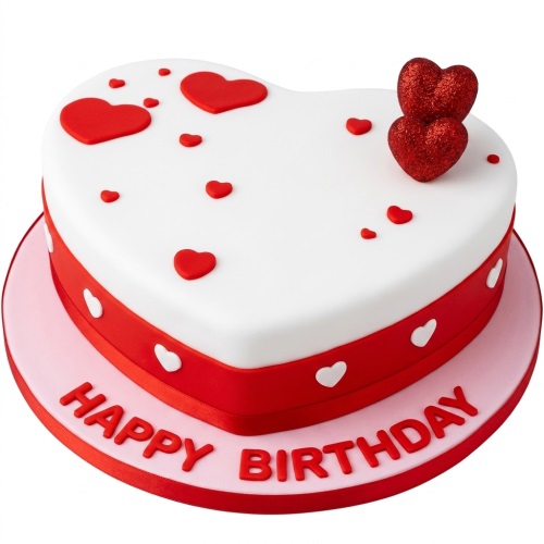 Heart-shaped birthday cake with red and white heart decorations and "Happy Birthday" message.