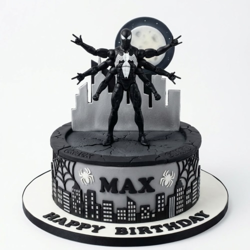 Two-tier black and grey Spiderman birthday cake with multi-armed figure, cityscape, and moon.