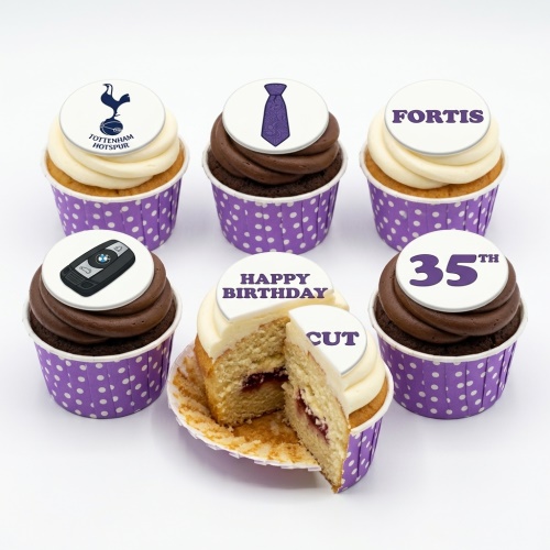 Birthday cupcakes with custom toppers including a sports logo, tie, and car key, in purple cases.