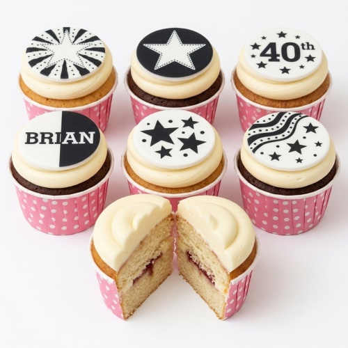 Monochrome cupcakes with black and white star and pattern toppers.