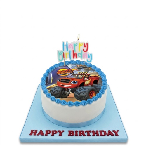 Round white birthday cake with edible image of Blaze and the Monster Machines, blue icing border, and 'Happy Birthday' candle topper.