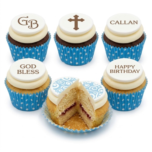 Set of personalised cupcakes with white buttercream, blue polka dot cases, and custom fondant toppers including a cross, initials, and messages.