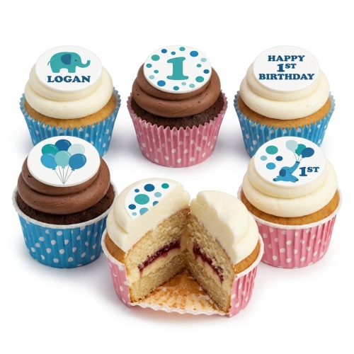 Assortment of 1st birthday cupcakes with blue elephant, balloons, and number one toppers.