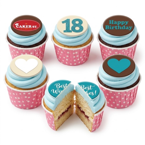 Assortment of personalised birthday cupcakes with light blue frosting, pink polka dot cases, and custom toppers including age, Happy Birthday, and hearts.
