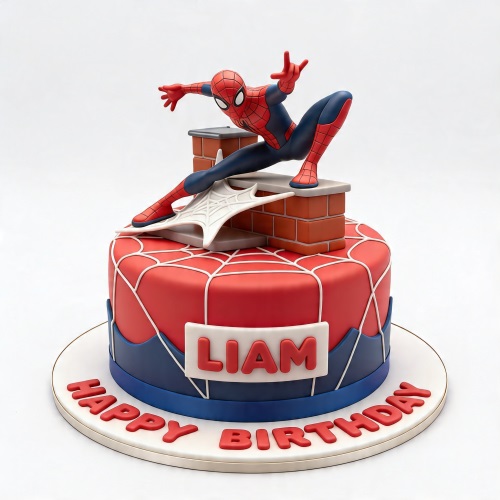 Round Spiderman themed birthday cake with a Spiderman figure, red and blue fondant, and white web design.