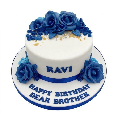 White birthday cake with blue fondant roses, blue ribbon, and gold and silver sprinkles.