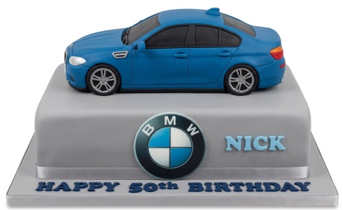 Blue BMW car model on a grey square birthday cake with BMW logo and custom message.