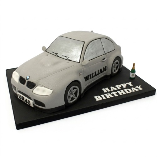 Grey sports car birthday cake with custom age license plate and personalised name on door, champagne bottle on black board.