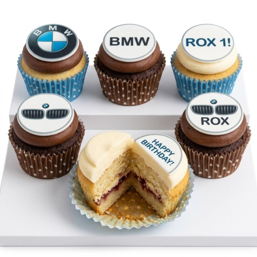 Cupcakes with BMW logos, BMW text, and BMW grille toppers, some with 'Happy Birthday' message.