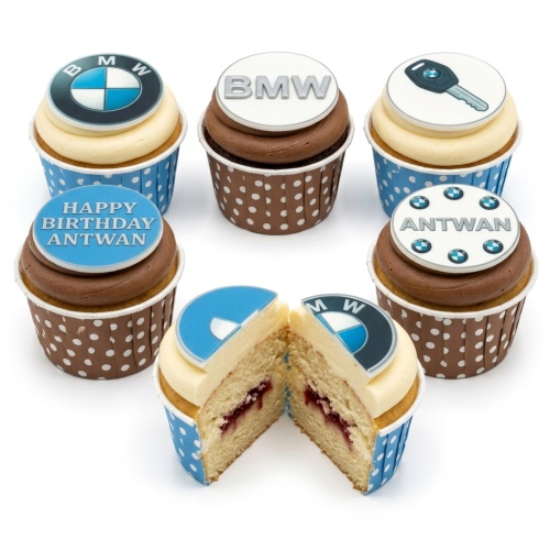 Assorted BMW themed birthday cupcakes with car logos, 'BMW' text, and car key toppers, some with custom messages.