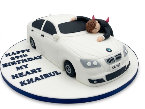 White BMW car birthday cake with a man in a suit and horns, custom message.