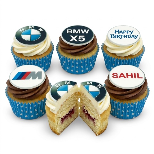 A selection of BMW themed birthday cupcakes with vanilla and chocolate frosting, featuring BMW logos, BMW M logo, and custom message toppers.