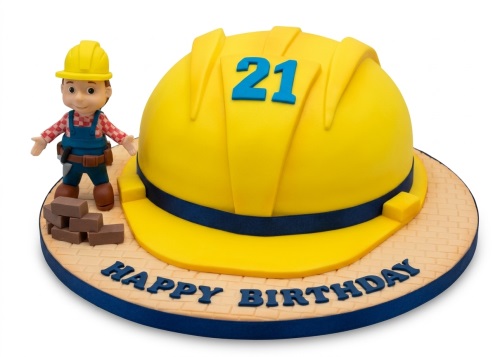 Yellow hard hat birthday cake with Bob The Builder figure, bricks, and custom age topper.