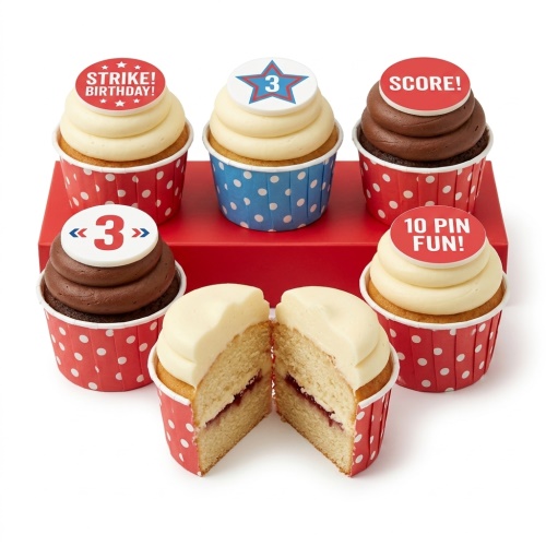 Six bowling themed birthday cupcakes with red and blue polka dot wrappers and various toppers.