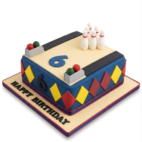 Rectangular bowling alley birthday cake with white pins, red and green bowling balls, and a custom age topper.
