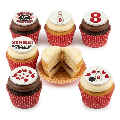 A selection of bowling-themed birthday cupcakes with red and white decorations, including bowling pins, balls, and a custom age topper.