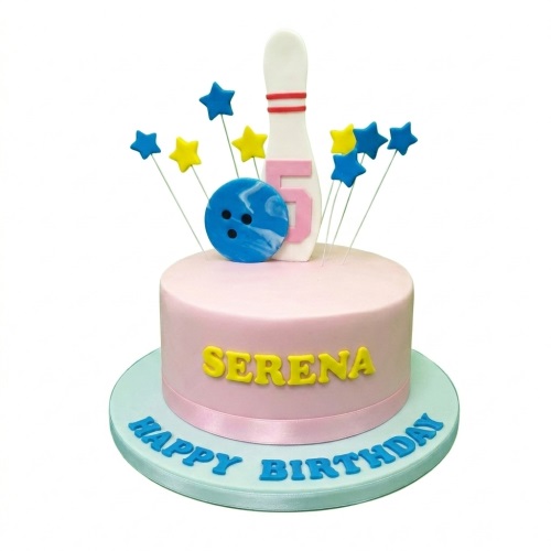 Pink round birthday cake with a white bowling pin, blue bowling ball, and blue and yellow star toppers.