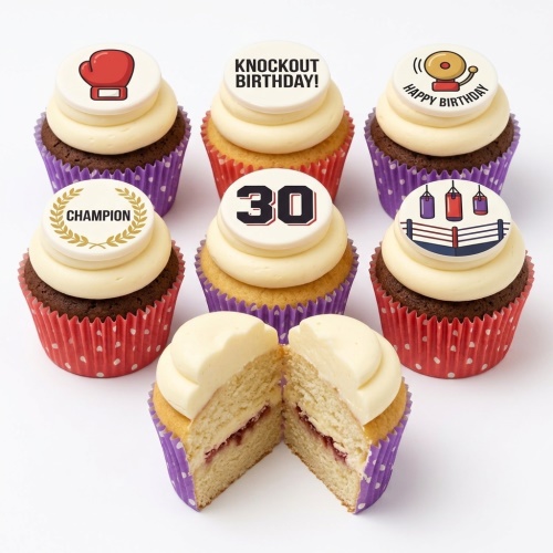Assortment of boxing-themed birthday cupcakes with a custom age topper, boxing gloves, and ring decorations.