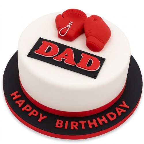 Round white birthday cake with red boxing gloves and a black plaque with "DAD" in red letters, and "HAPPY BIRTHDAY" around the base.
