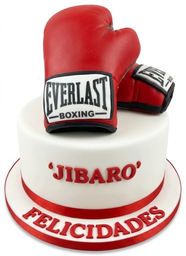 White birthday cake with red boxing gloves and red ribbon.