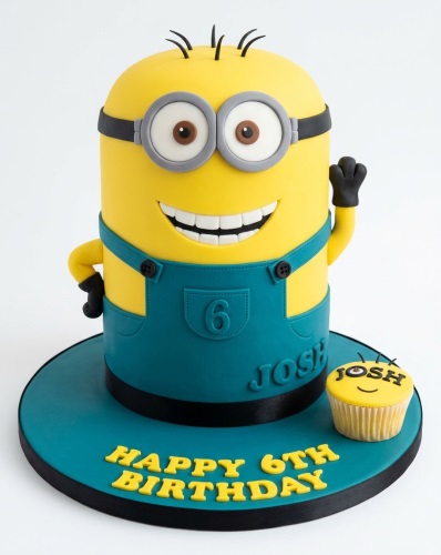 Yellow Minion character birthday cake with blue overalls and custom age.