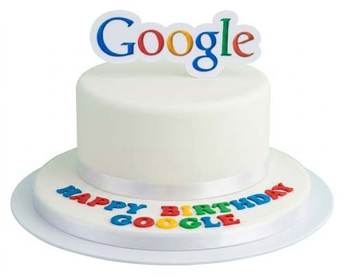 Two-tier white fondant cake with a Google logo topper and "Happy Birthday Google" text.