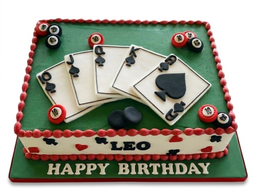 Rectangular green casino theme birthday cake with playing cards, poker chips, and billiard balls.