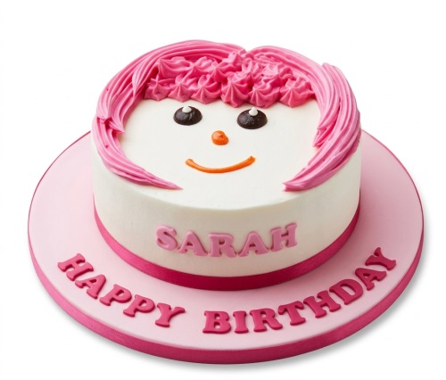Round white doll face birthday cake with pink piped hair and a personalised message.