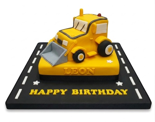 Yellow digger construction birthday cake with "Happy Birthday" and a custom name.