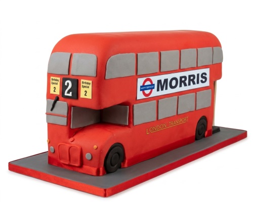Red London double-decker bus shaped birthday cake with custom age and name.