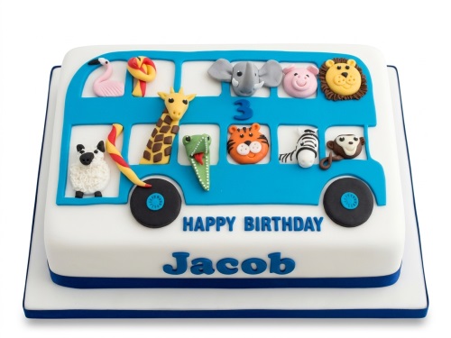 White fondant cake with a blue bus featuring various fondant animal faces, a custom age number, and a personalised birthday message.
