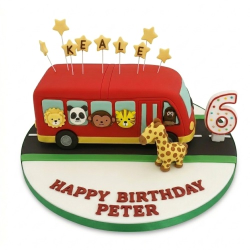 Red bus birthday cake with safari animals in windows, giraffe figure, and custom age topper.