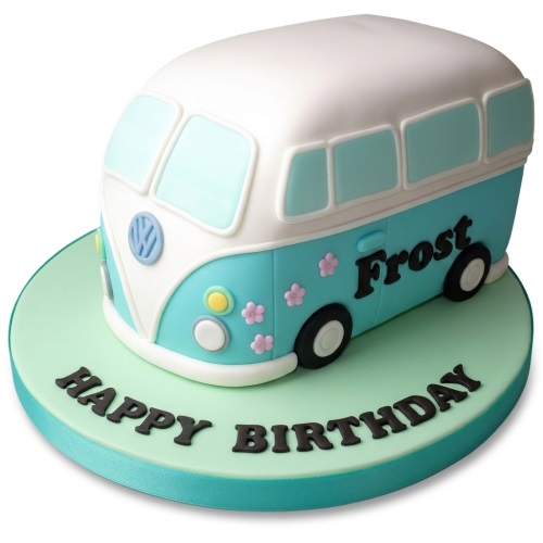 3D sculpted camper van birthday cake in blue and white with small pink flowers and a custom message on the board.