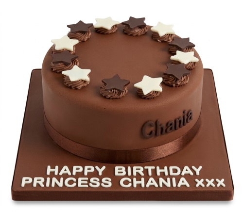 Round chocolate birthday cake with white and dark chocolate stars and a brown ribbon.