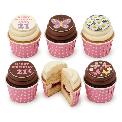 A selection of butterfly and daisy themed birthday cupcakes with pink polka dot wrappers and custom age toppers.