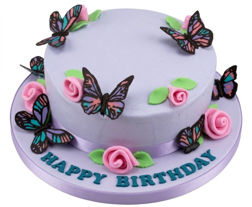 Round lavender birthday cake with colourful edible butterflies and pink roses.
