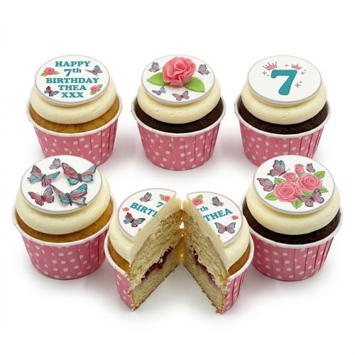 Six cupcakes with butterfly and rose toppers, some with custom age and message, in pink polka dot wrappers.