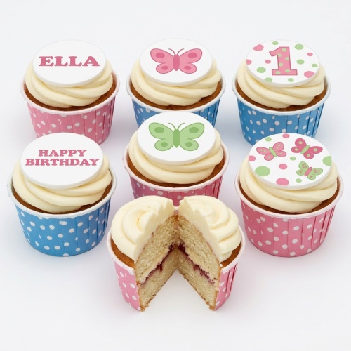 Butterfly themed birthday cupcakes with pink and green toppers, polka dot wrappers, and custom age option.