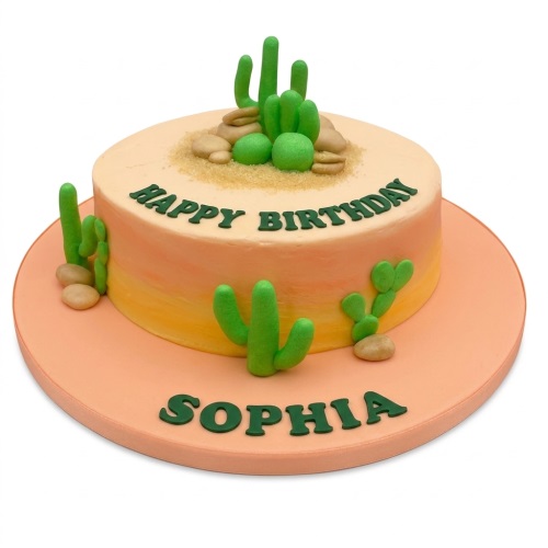 Round single-tier birthday cake with green cacti and sand decorations on an orange and yellow ombre base.