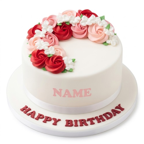 White round birthday cake with red and pink piped roses, white flowers, and a personalised message.